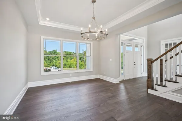 a view of staircase with wooden floor and white walls