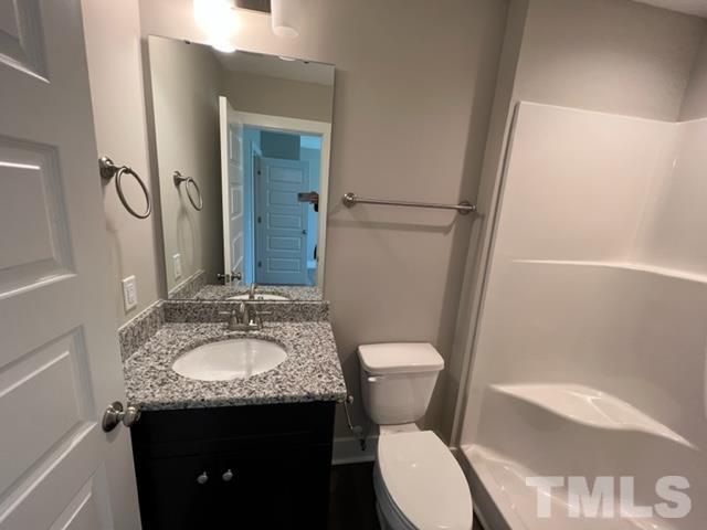 355 South Church Street Coats, NC 27521 - Photo 11 of 17 a bathroom with a granite countertop sink toilet and shower