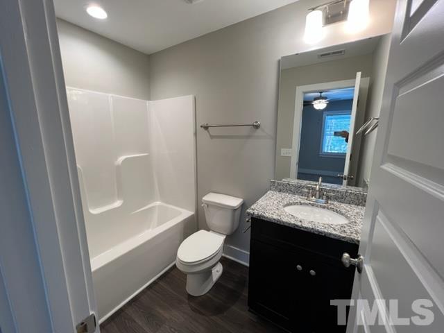 355 South Church Street Coats, NC 27521 - Photo 15 of 17 a bathroom with a granite countertop sink toilet and shower