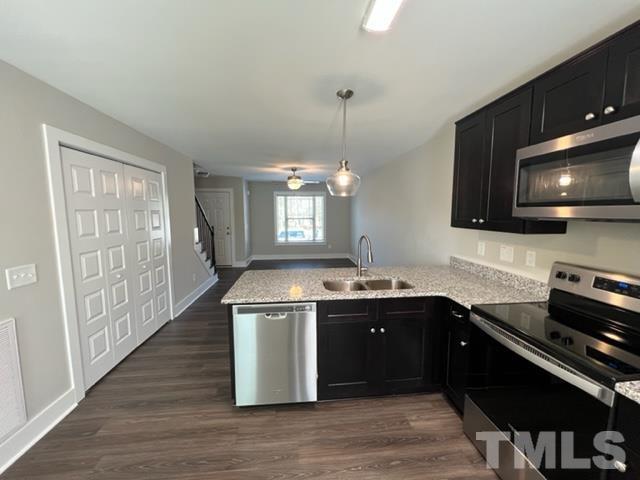 355 South Church Street Coats, NC 27521 - Photo 5 of 17 a kitchen with stainless steel appliances granite countertop a sink stove and microwave
