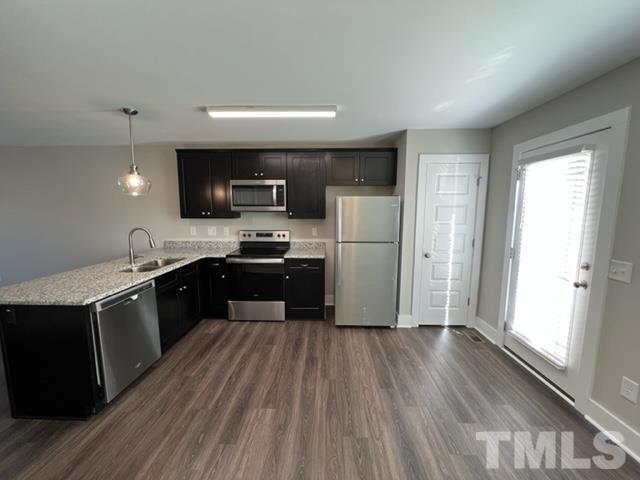355 South Church Street Coats, NC 27521 - Photo 8 of 17 a large kitchen with a wooden floor a large window and a refrigerator
