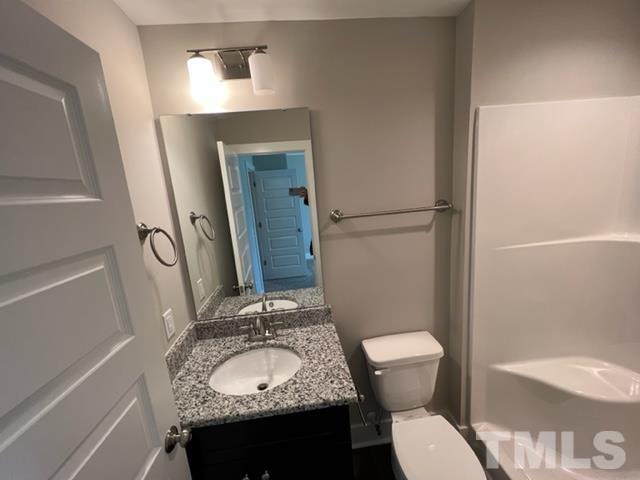 355 South Church Street Coats, NC 27521 - Photo 10 of 17 a bathroom with a granite countertop sink toilet and shower