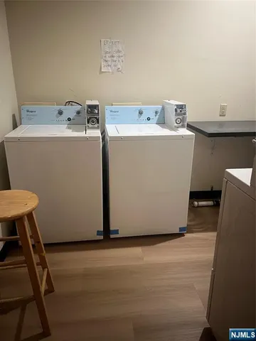 a utility room with a wooden floor washer and dryer