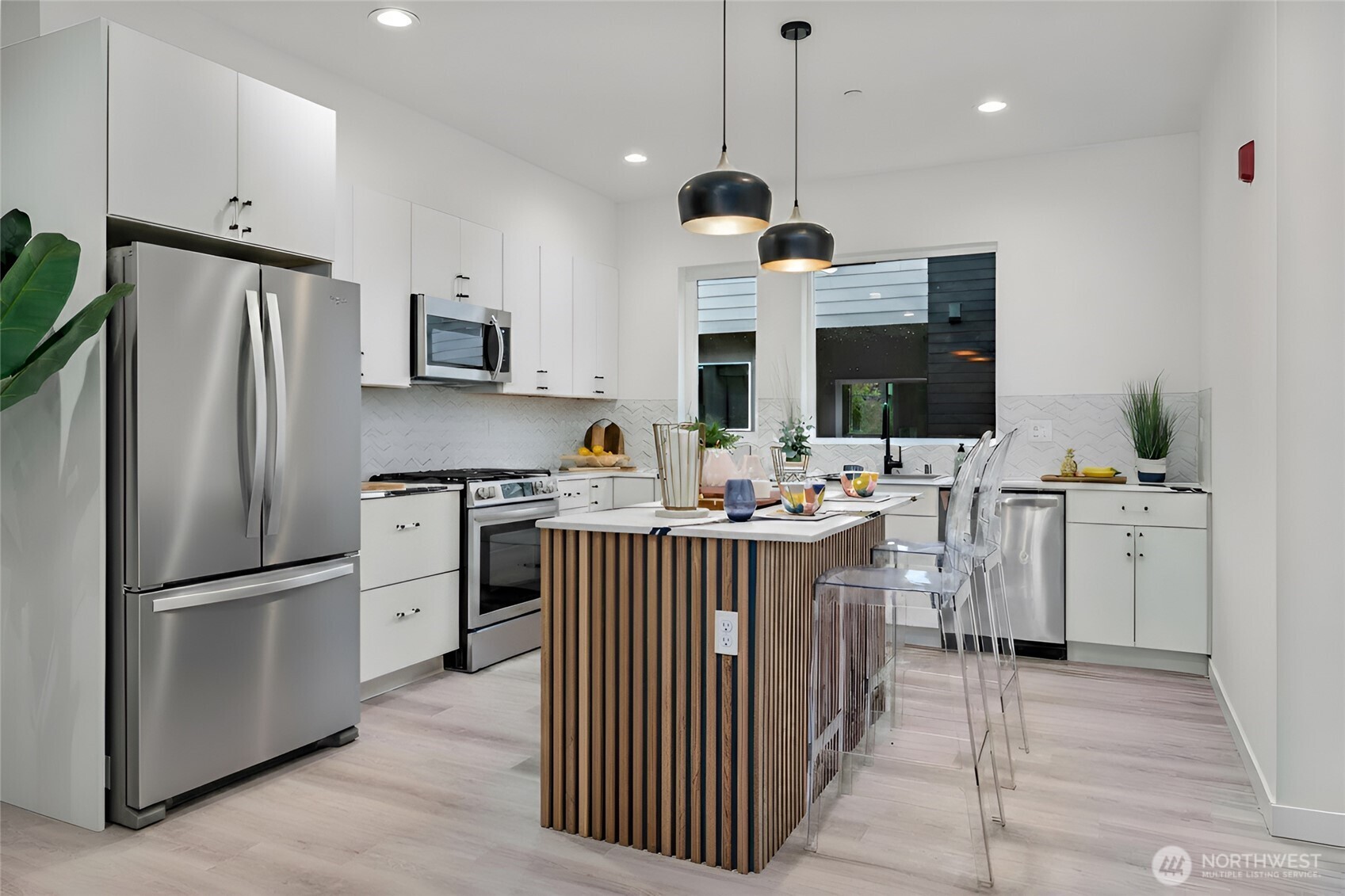 11535 17th Place Southwest Burien, WA 98146 - Photo 5 of 40 a kitchen with white cabinets and stainless steel appliances