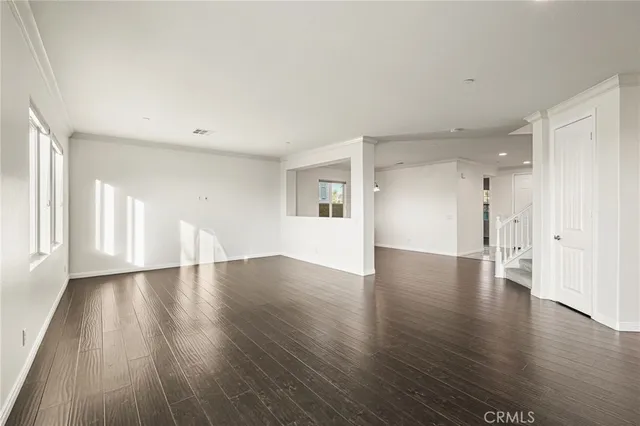a kitchen with stainless steel appliances granite countertop sink stove refrigerator and cabinets