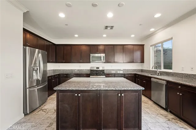a kitchen with a stove a sink and a microwave