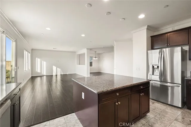 a large kitchen with stainless steel appliances granite countertop a large stove a sink and a microwave