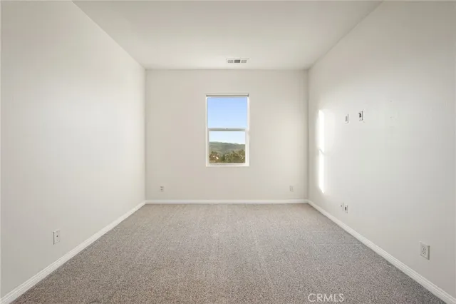 an empty room with entrance and ceiling fan