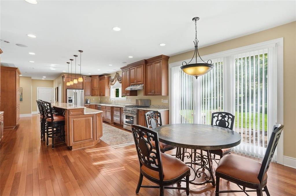 1040 Chanticleer Drive Crescent, PA 15046 - Photo 15 of 50 a kitchen with stainless steel appliances a dining table chairs and white cabinets