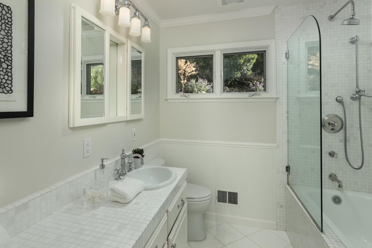 10490 Florence Drive Cupertino, CA 95014 - Photo 12 of 17 a bathroom with a granite countertop sink mirror and vanity