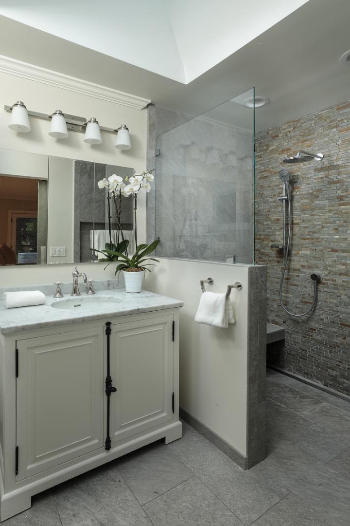 10490 Florence Drive Cupertino, CA 95014 - Photo 14 of 17 a bathroom with a granite countertop sink mirror and shower