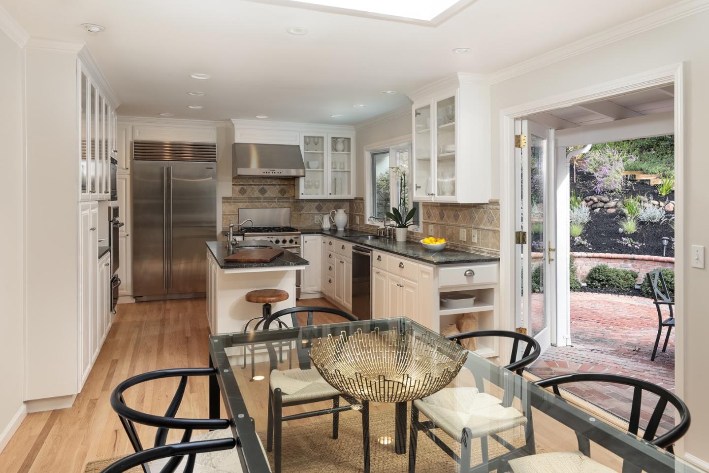 10490 Florence Drive Cupertino, CA 95014 - Photo 6 of 17 a kitchen with a dining table chairs and chandelier