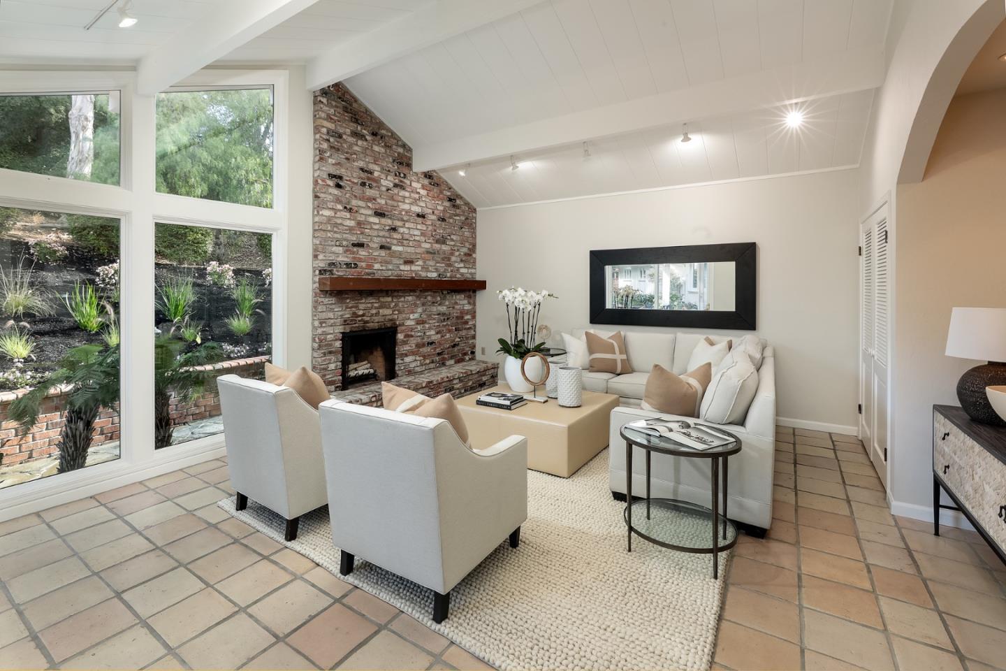 10490 Florence Drive Cupertino, CA 95014 - Photo 8 of 17 a living room with furniture a fireplace and a floor to ceiling window