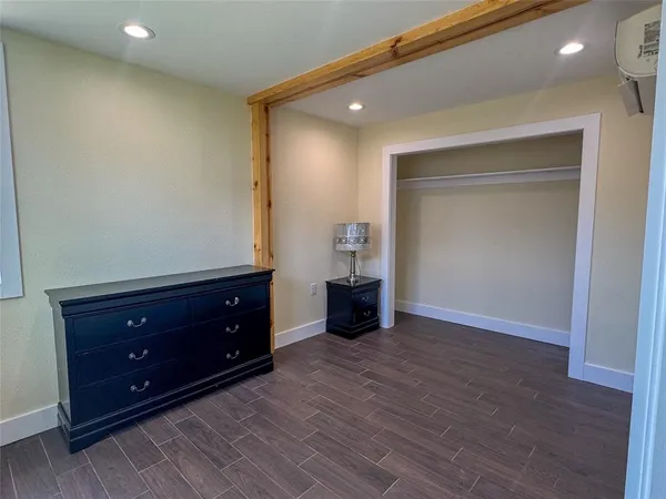 wooden floor with a dresser in it