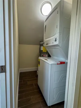 a utility room with wooden floor washer and dryer