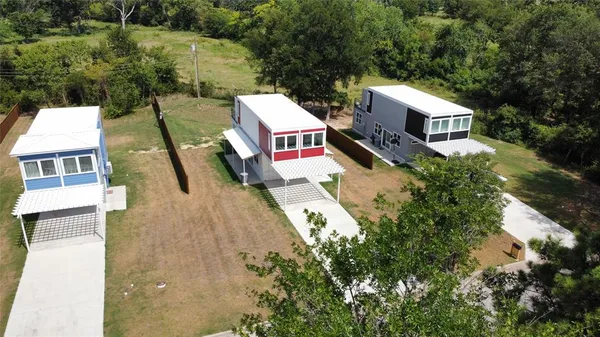 an aerial view of a house with a yard