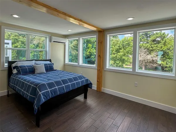 a bedroom with a large bed and a large window