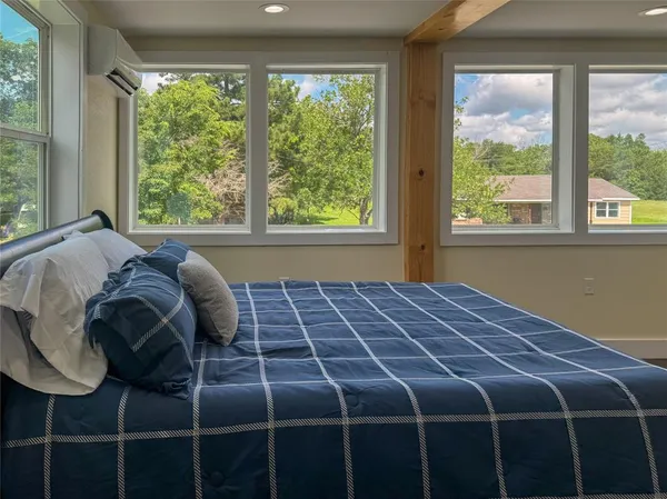 a bed sitting in a bedroom next to a window