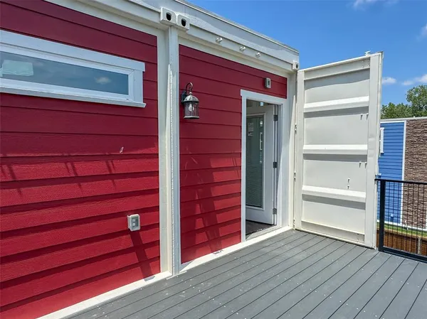 a view of an empty room and wooden floor and cabinet