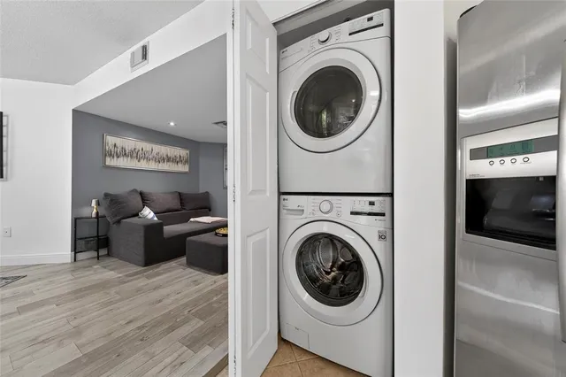 a living room with furniture and a washer dryer
