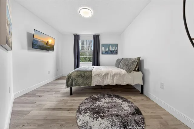 a bedroom with a large bed and a window