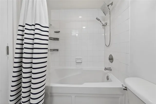 a bathroom with a bathtub and shower
