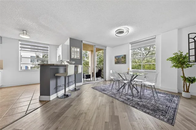 a dining room with furniture and wooden floor