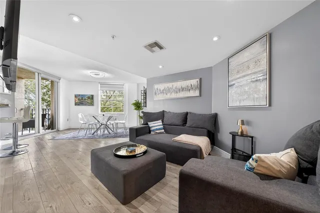 a living room with furniture and wooden floor