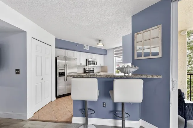 a kitchen with kitchen island a appliances counter space and a window