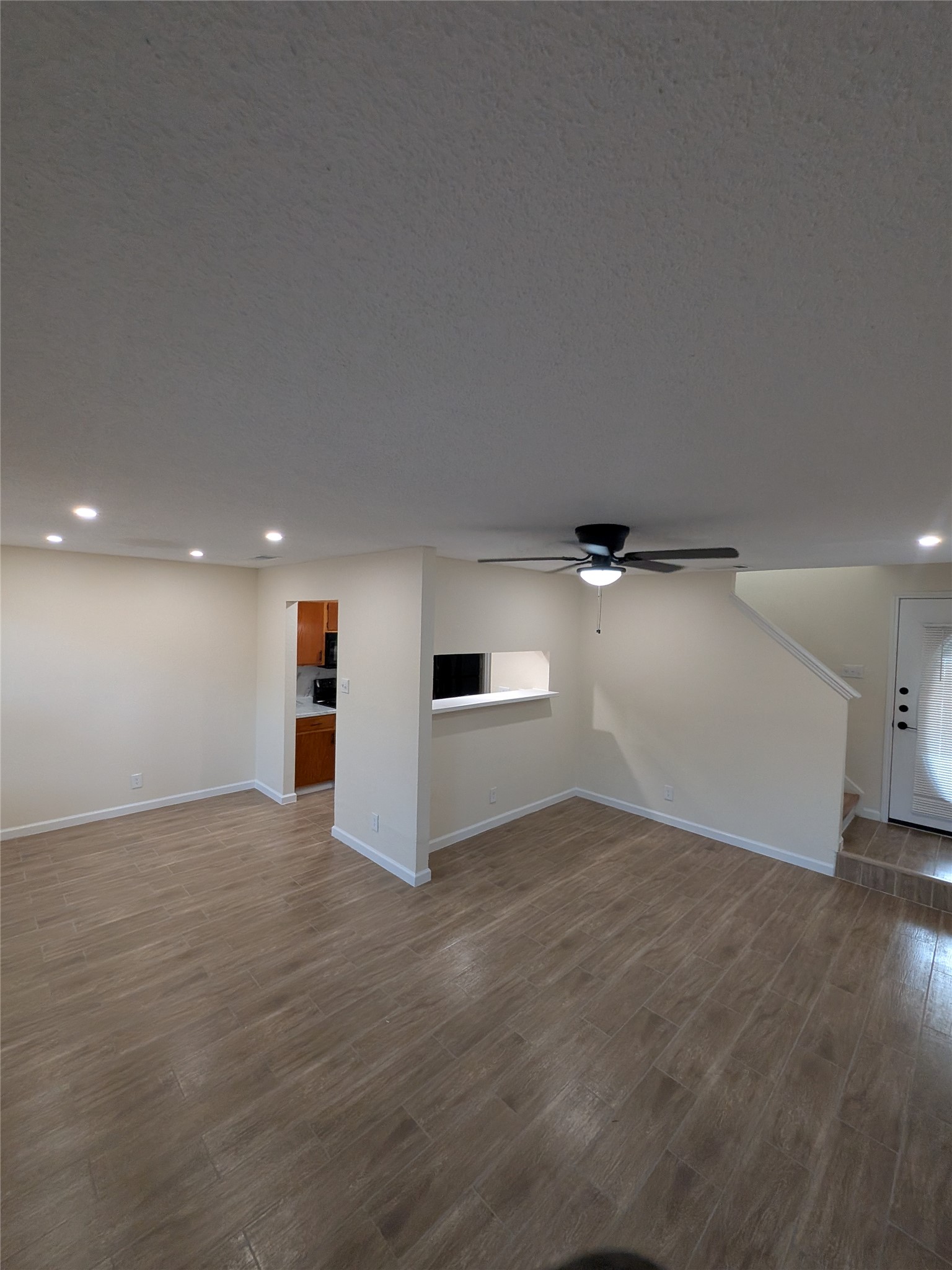 13303 Lyndhurst Street, Unit B Austin, TX 78729 - Photo 3 of 13 Porcelain tile flooring extends throughout this versatile living space, featuring recessed lighting and a ceiling fan.