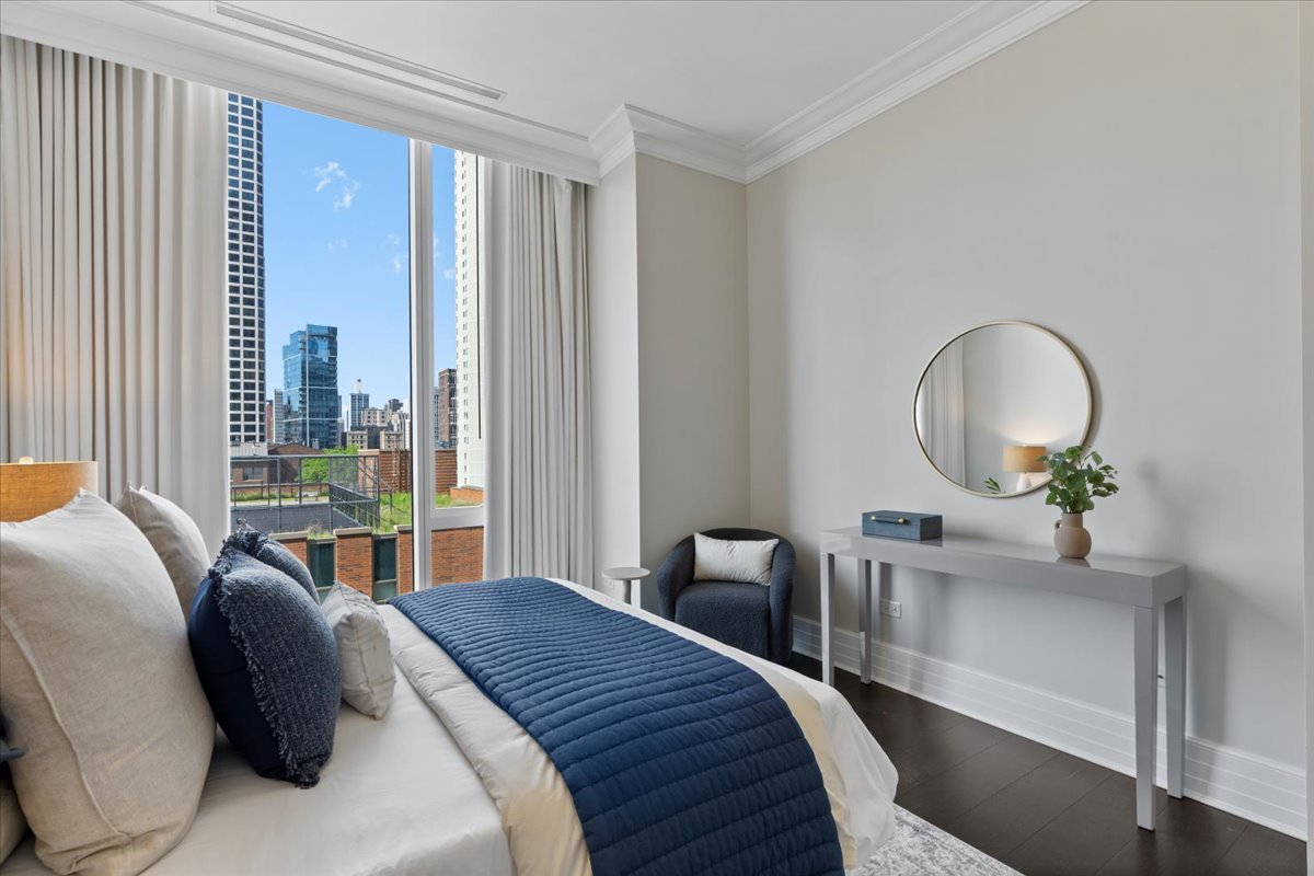 9 West Walton Street, Unit 702 Chicago, IL 60610 - Photo 27 of 38 a bedroom with a bed lamps and a large window