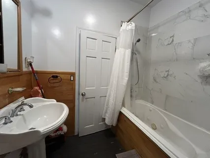 a bathroom with a sink a toilet and shower
