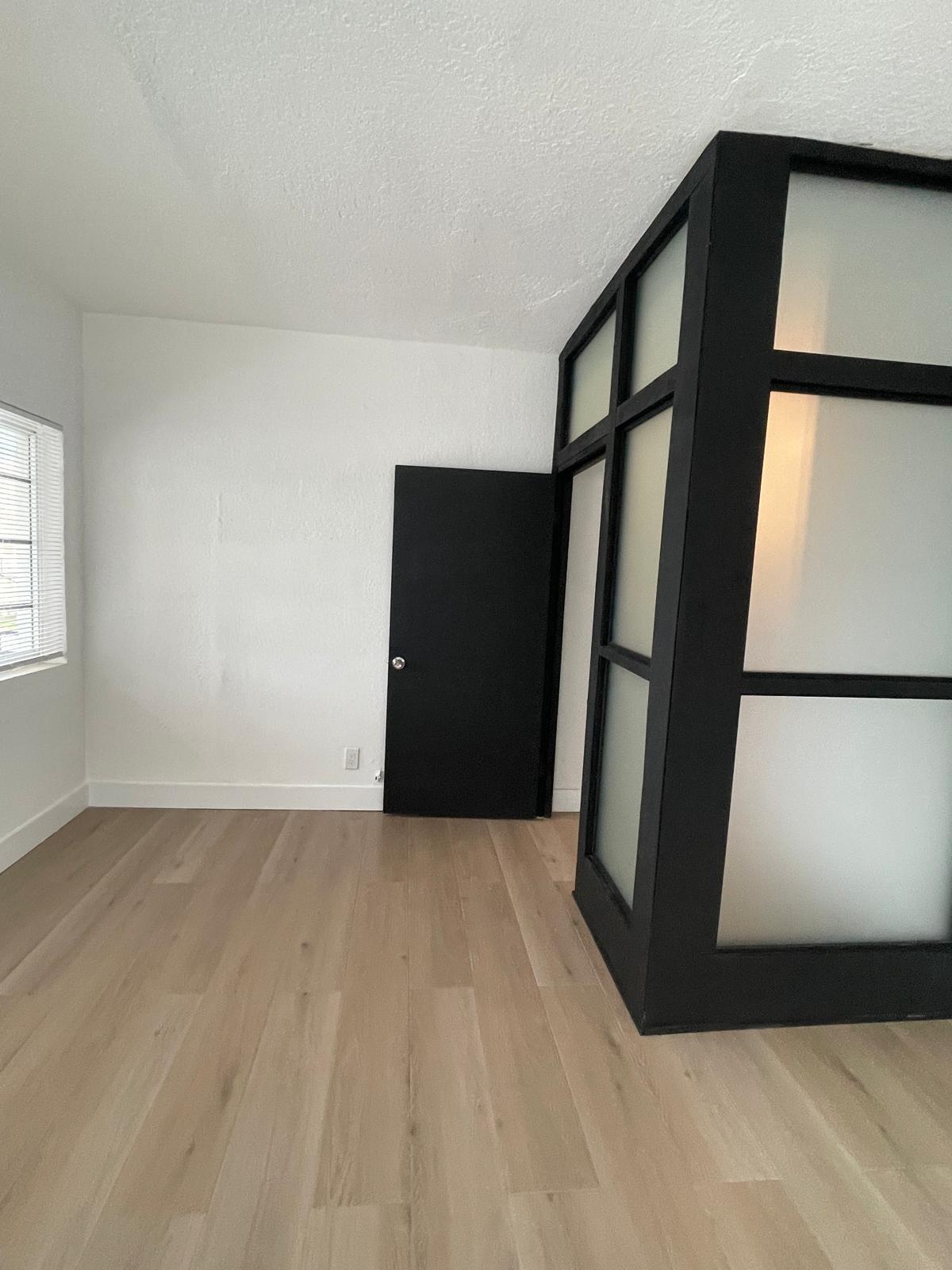 6910 Byron Avenue, Unit 3 Miami Beach, FL 33141 - Photo 2 of 12 a view of an empty room with a window