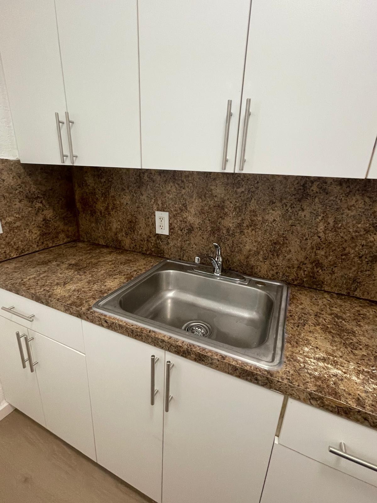 6910 Byron Avenue, Unit 3 Miami Beach, FL 33141 - Photo 5 of 12 a close view of sink and tap
