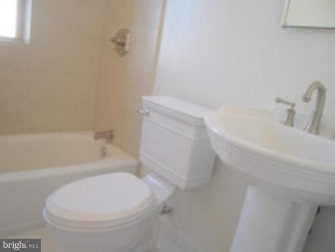 1673 Park Road Northwest, Unit 405 Washington, DC 20010 - Photo 8 of 9 All new ceramic tiled bath with a pedestal sink