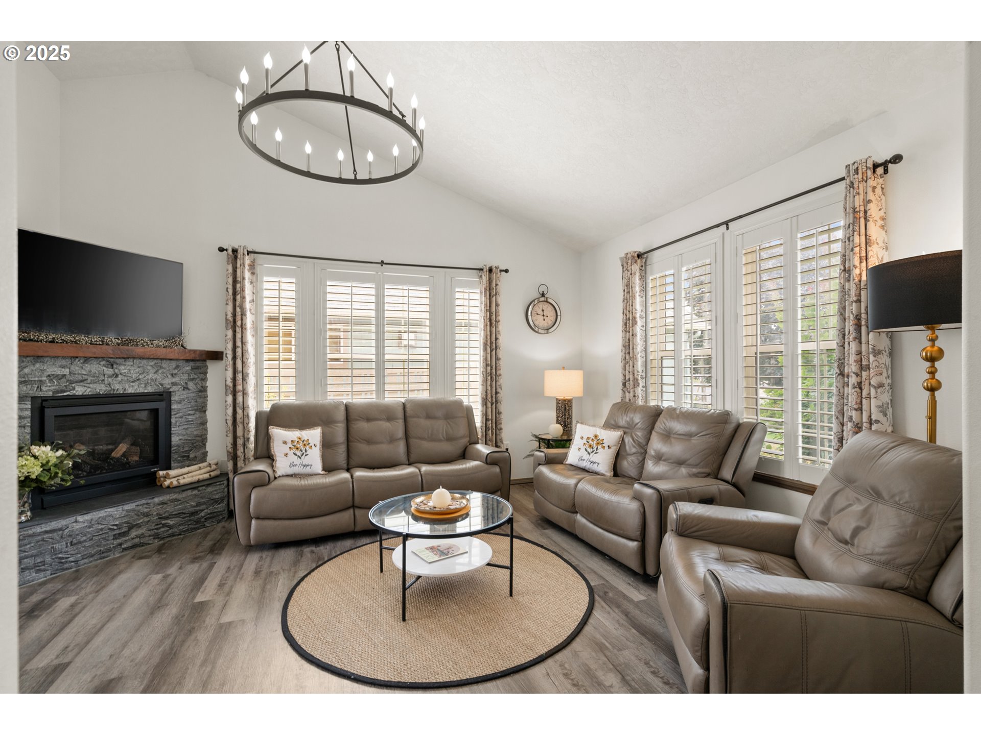 1822 Southwest 3rd Street Pendleton, OR 97801 - Photo 17 of 34 a living room with furniture a fireplace a flat screen tv and a large window