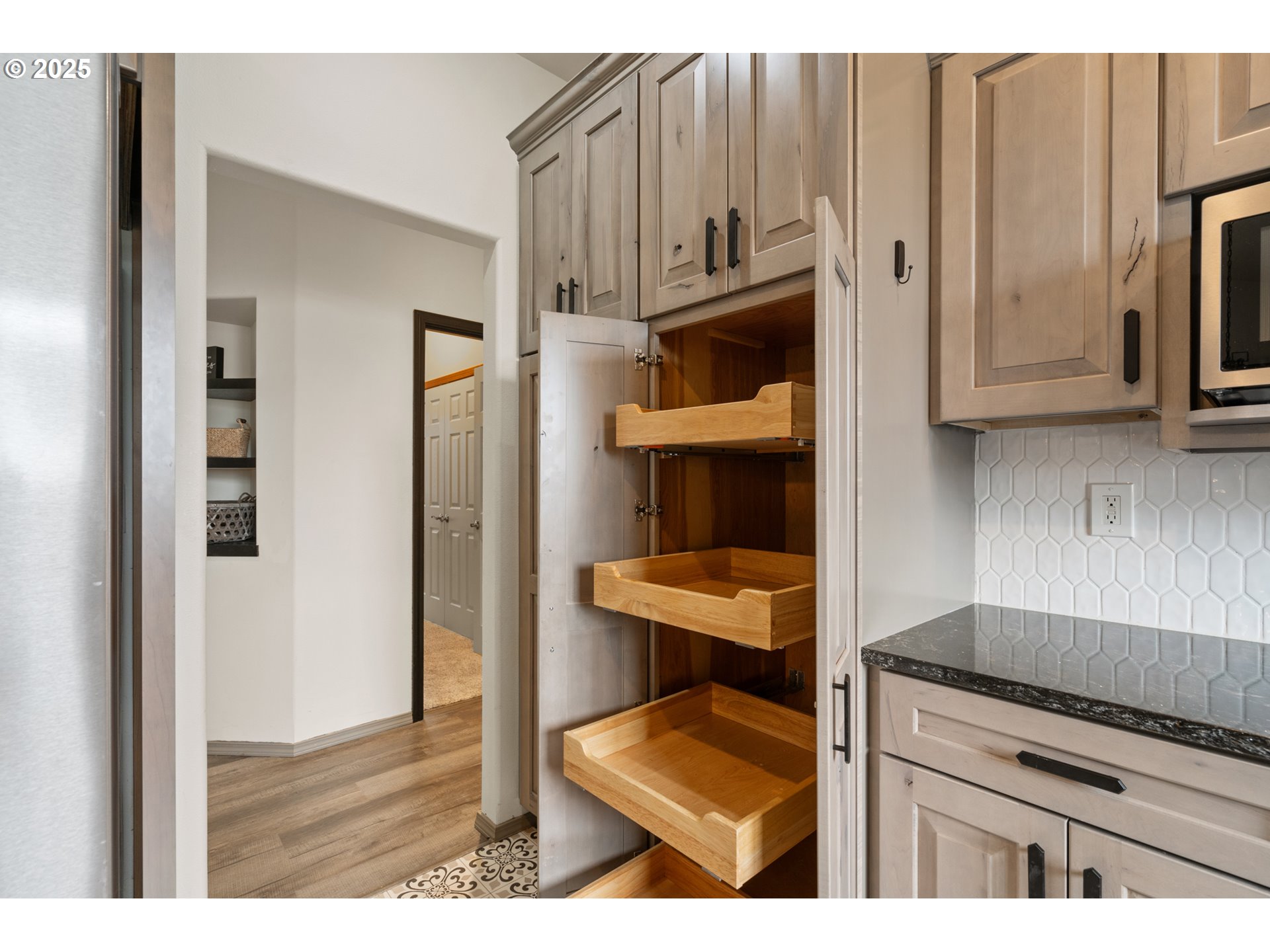 1822 Southwest 3rd Street Pendleton, OR 97801 - Photo 10 of 34 a kitchen with granite countertop a stove top oven microwave and cabinets