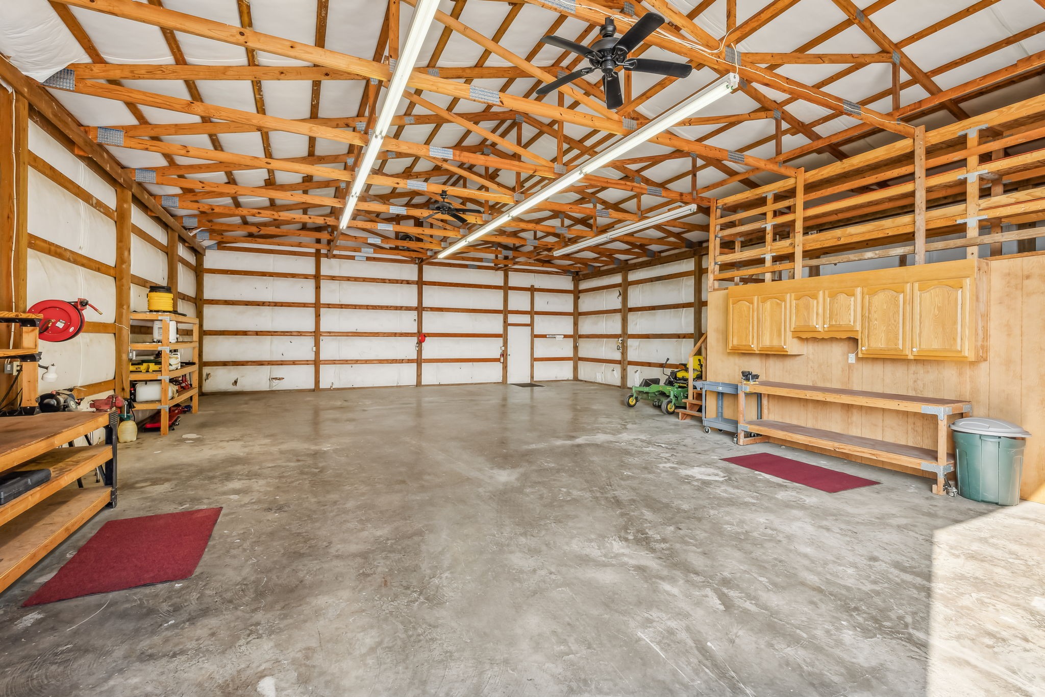 4152 Old Coopertown Road Springfield, TN 37172 - Photo 52 of 70 Shop has 120 and 240 amps, two large fans, cabinet storage space, open shelving, two retractable 50ft extension cords so never without access to power, large 13ft sliding door that locks,