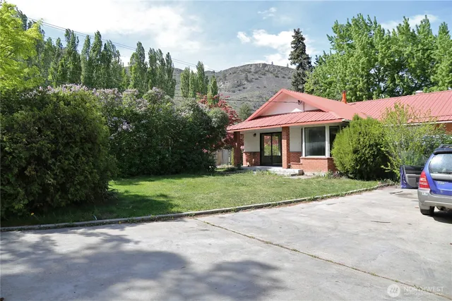 a view of a patio with a table and chairs under an umbrella