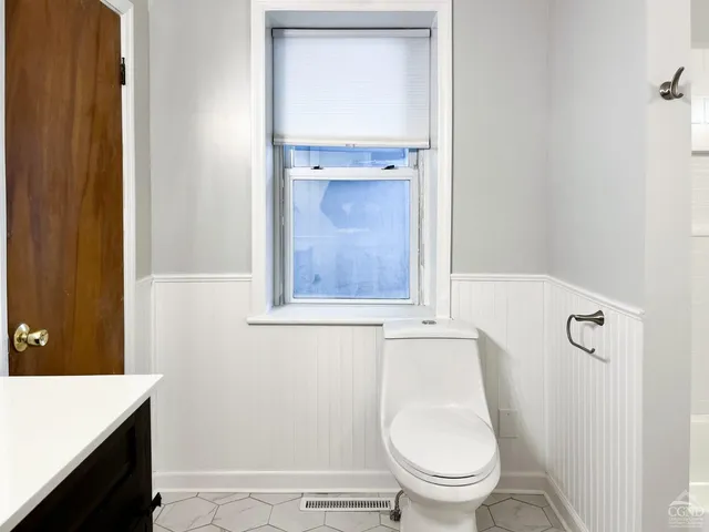 a bathroom with a toilet and a sink