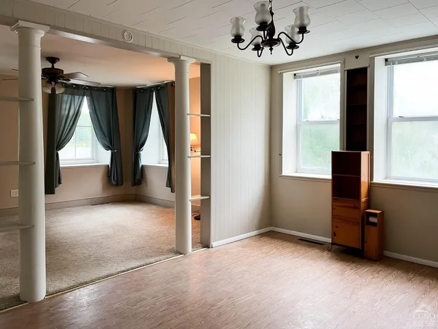 a view of room with window and a ceiling fan