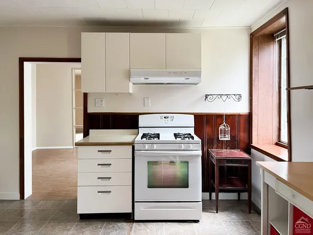 a kitchen with a stove and a cabinet