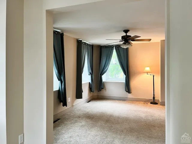 an empty room with windows and closet