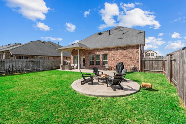 a view of a house with a backyard porch and sitting area