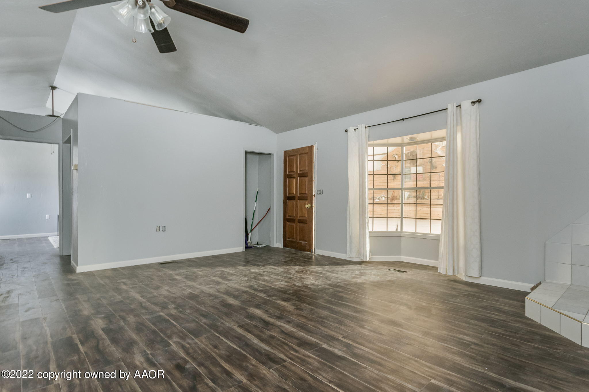 100 Alamo Street Claude, TX 79019 - Photo 17 of 39 a view of an empty room with wooden floor and a window