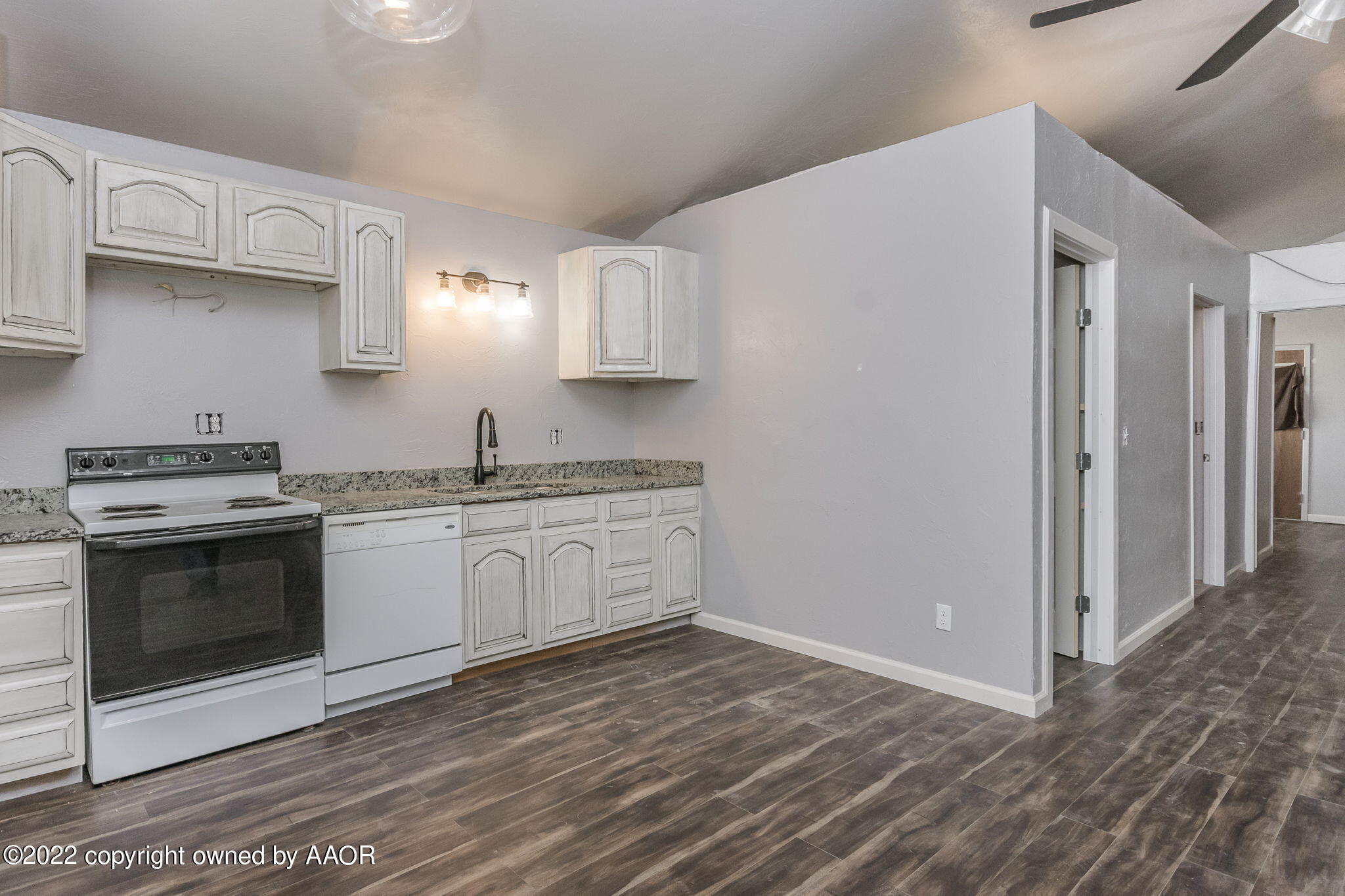 100 Alamo Street Claude, TX 79019 - Photo 18 of 39 a kitchen with granite countertop a stove and a sink