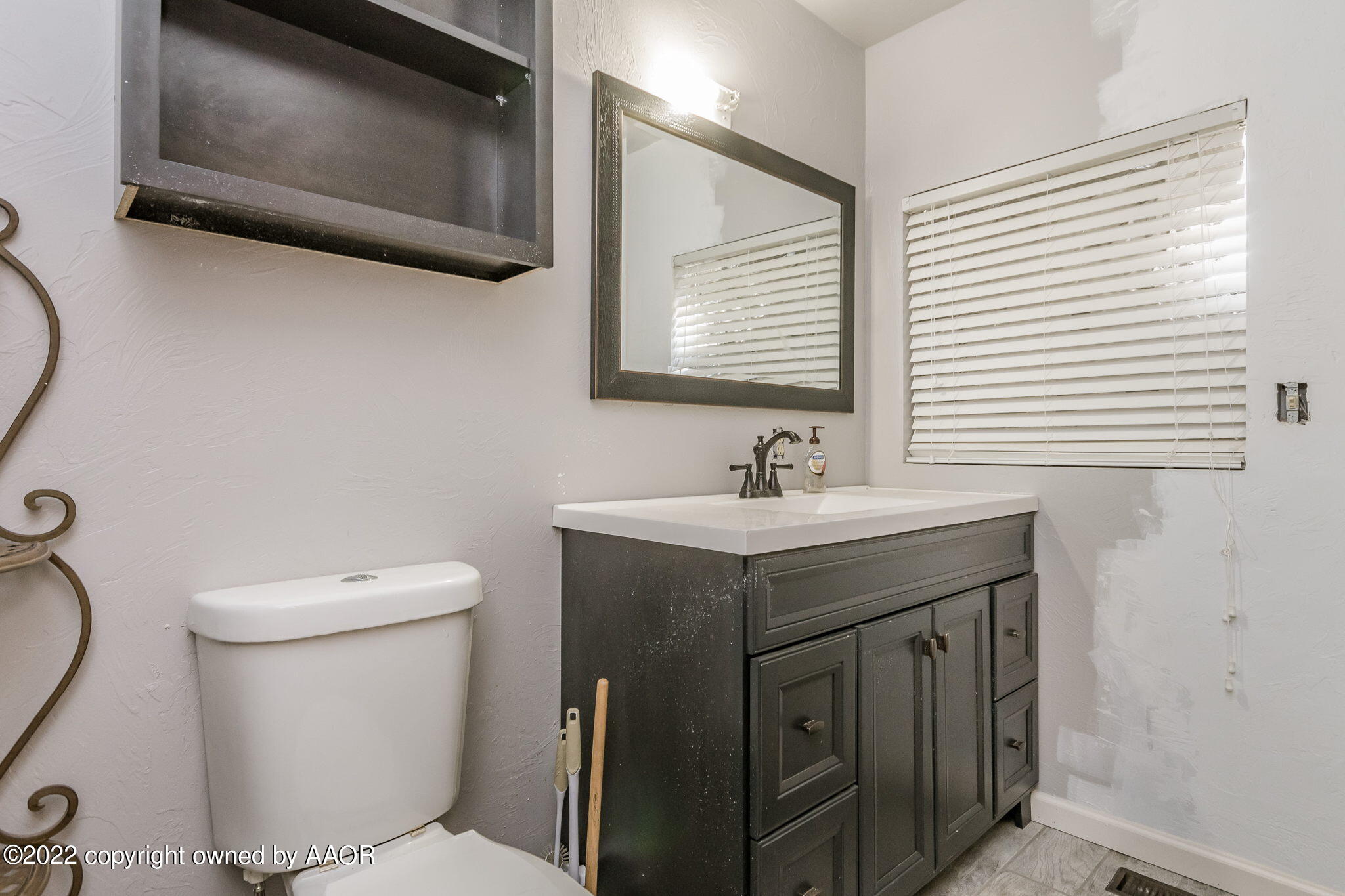 100 Alamo Street Claude, TX 79019 - Photo 22 of 39 a bathroom with a sink toilet and mirror