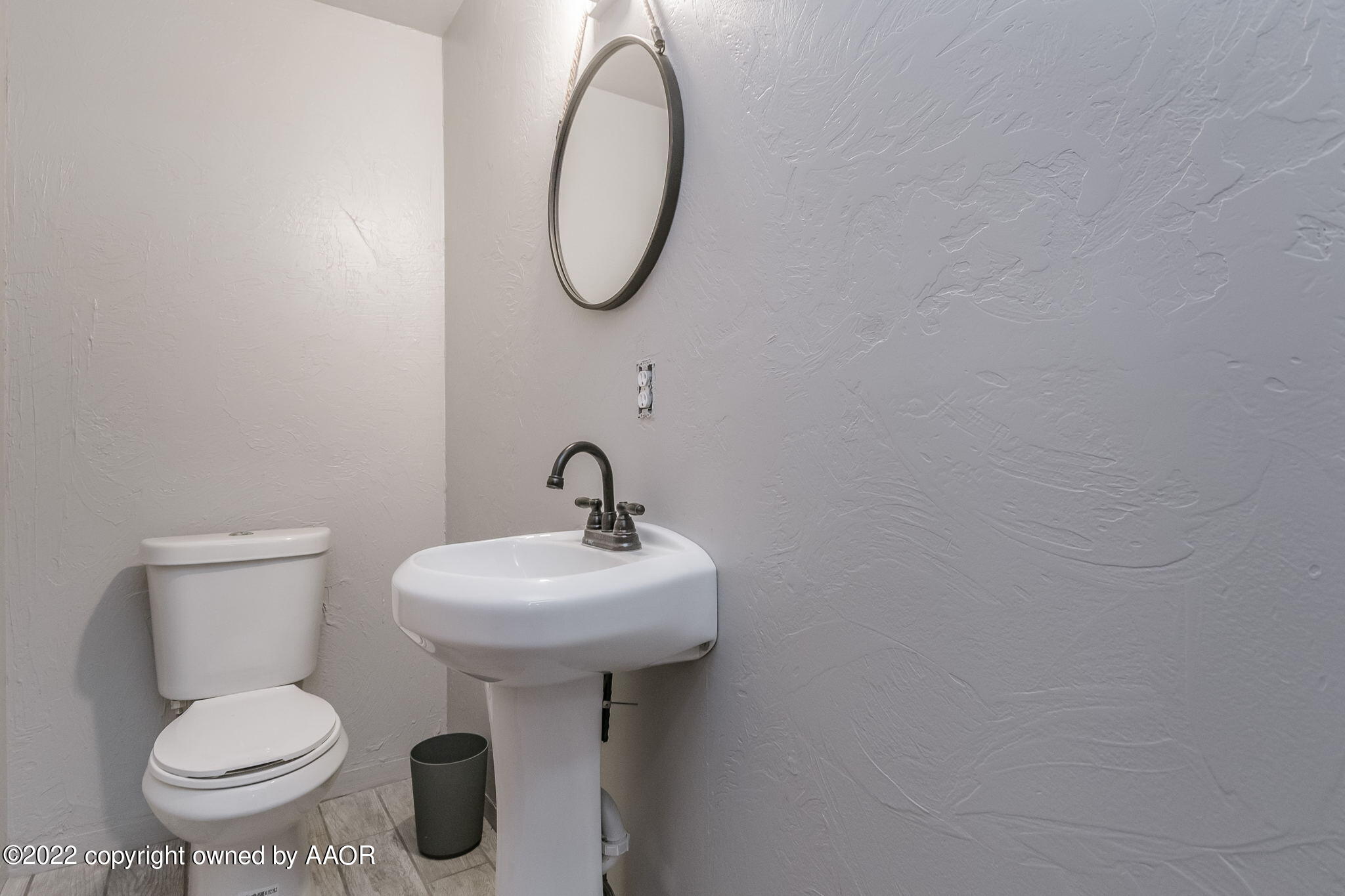 100 Alamo Street Claude, TX 79019 - Photo 25 of 39 a bathroom with a sink toilet and a mirror