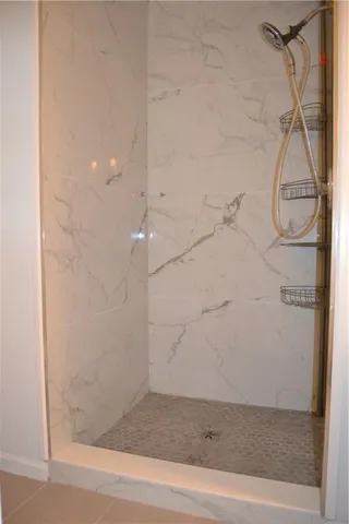 a bathroom that has a glass shower door