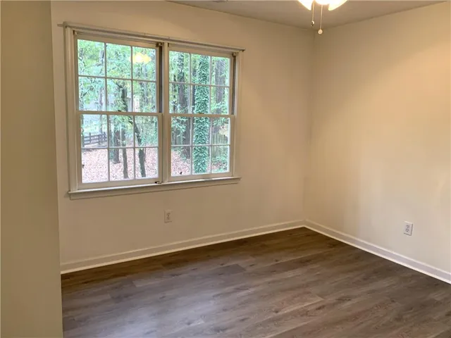 a view of a room with wooden floor and windows